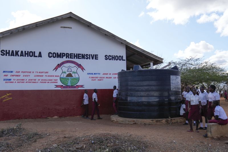 Shakahola Comprehensive School children play outside the classrooms near the scene where dozens of bodies were found in shallow graves in the village of Shakahola, near the coastal city of Malindi, in southern Kenya, on Thursday, Sept. 5, 2024. (AP Photo/Brian Inganga)