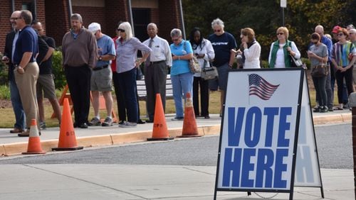 Early voters wait outside George Pierce Park Community Recreation Center in Suwanee on Wednesday, Oct. 26, 2016. HYOSUB SHIN / HSHIN@AJC.COM