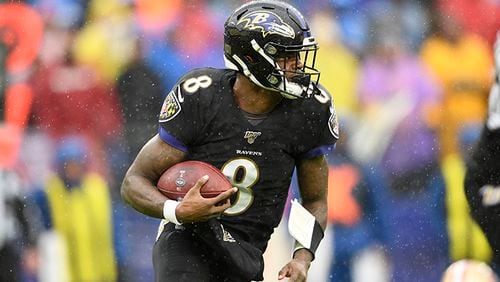 Baltimore Ravens quarterback Lamar Jackson runs with the ball in the first half of a game against the San Francisco 49ers on Dec. 1 in Baltimore.