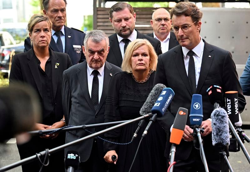 Hendrik W'st, right, Minister President of North Rhine-Westphalia, Federal Minister of the Interior Nancy Faeser, second right, and Herbert Reul, third right, Minister of the Interior of North Rhine-Westphalia, speak at a press conference following the Friday attack at the festival, in Solingen, Germany, Saturday, Aug. 24, 2024. (Henning Kaiser/dpa via AP)