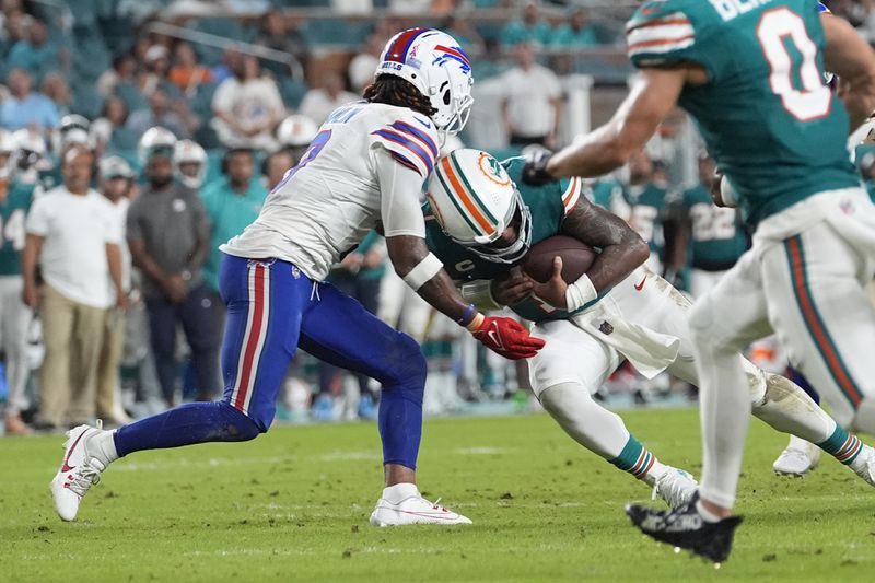 Miami Dolphins quarterback Tua Tagovailoa (1) and Buffalo Bills safety Damar Hamlin (3) collide during the second half of an NFL football game, Thursday, Sept. 12, 2024, in Miami Gardens, Fla. Tagovailoa suffered a concussion on the play. (AP Photo/Lynne Sladky)