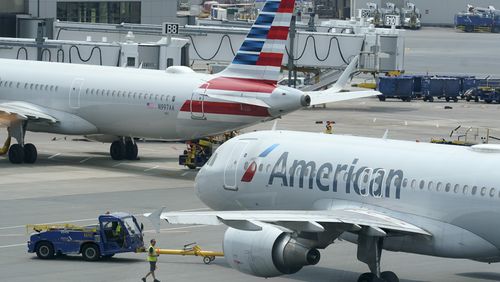 FILE - American Airlines passenger jets prepare for departure, July 21, 2021, near a terminal at Boston Logan International Airport in Boston. (AP Photo/Steven Senne, File)