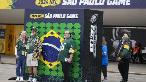 Fans pose for a picture before an NFL football game between the Philadelphia Eagles and the Green Bay Packers on Friday, Sept. 6, 2024, at the Neo Quimica Arena in Sao Paulo. (AP Photo/Andre Penner)