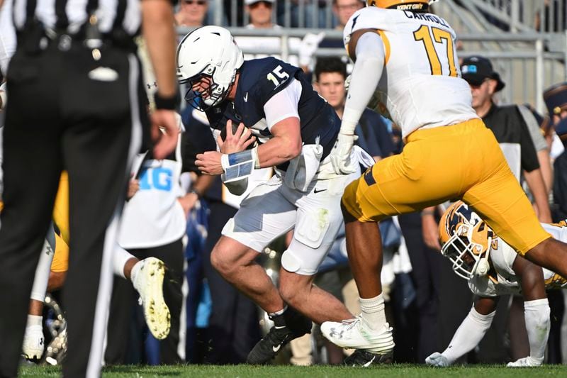 Penn State quarterback Drew Allar (15) scores a touchdown against Kent State defensive lineman Mattheus Carroll (17) during the second quarter of an NCAA college football game, Saturday, Sept. 21, 2024, in State College, Pa. (AP Photo/Barry Reeger)