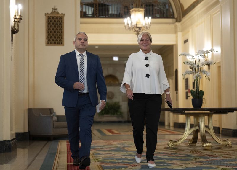 Fairmont Chateau Laurier General Manager Genevieve Dumas, right, speaks with Ottawa Police Services Detective Akiva Gellar as they make their way to a news conference to speak about the stolen Yousuf Karsh portrait of Winston Churchill, during a news conference in the hotel in Ottawa, Canada, Wednesday, Sept. 11, 2024. (Adrian Wyld/The Canadian Press via AP)