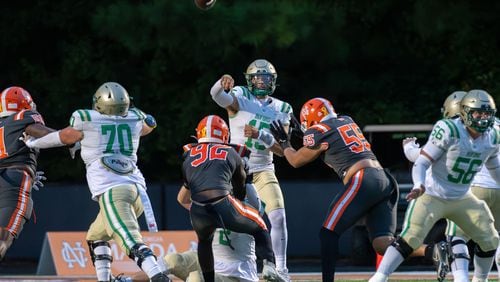 Buford's quarterback, Dylan Raiola, makes a pass during the Buford at North Cobb football game Friday night, September 1, 2023. (Jamie Spaar for the Atlanta Journal Constitution)