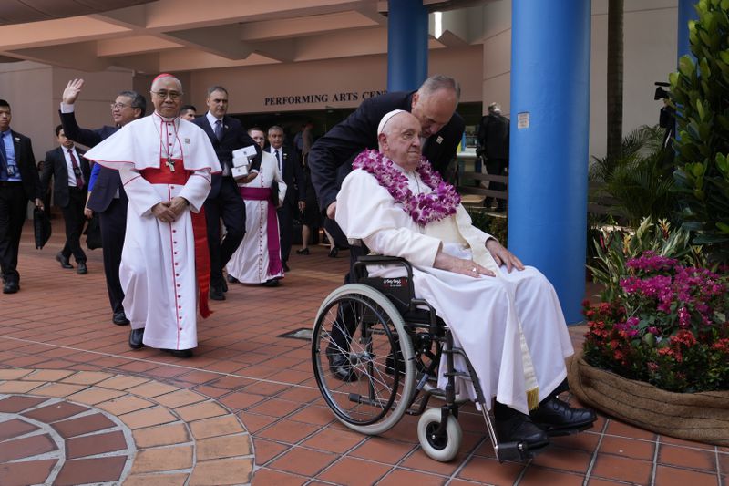 From right, Pope Francis, Archbishop of Singapore William Seng Chye Goh, and Singapore's Minister of Culture Edwin Tong attend an interreligious meeting with young people at the Catholic Junior College in Singapore, Friday, Sept. 13, 2024. Pope Francis is wrapping up his visit to Singapore by praising its tradition of interfaith harmony. (AP Photo/Gregorio Borgia)