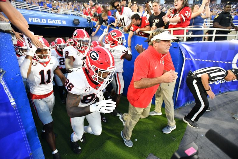 Georgia head coach Kirby Smart and players take the field before their Sept. 14 game at Kentucky.