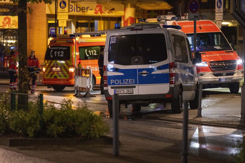 Emergency vehicles near the scene where people were killed and injured in an attack at a festival in Solingen, western Germany, the German dpa news agency reported, Friday, Aug. 23, 2024. (Gianni Gattus/dpa via AP)