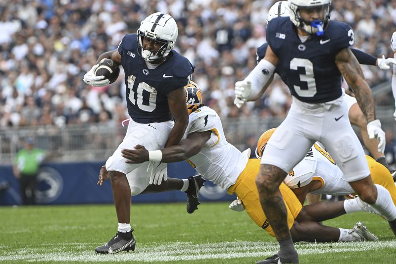 Penn State running back Nicholas Singleton (10) runs against Kent State during the first quarter of an NCAA college football game, Saturday, Sept. 21, 2024, in State College, Pa. (AP Photo/Barry Reeger)