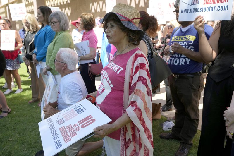 Anti-abortion protesters gather for a news conference after Arizona abortion-rights supporters deliver over 800,000 petition signatures to the capitol to get abortion rights on the November general election ballot Wednesday, July 3, 2024, in Phoenix. (AP Photo/Ross D. Franklin)
