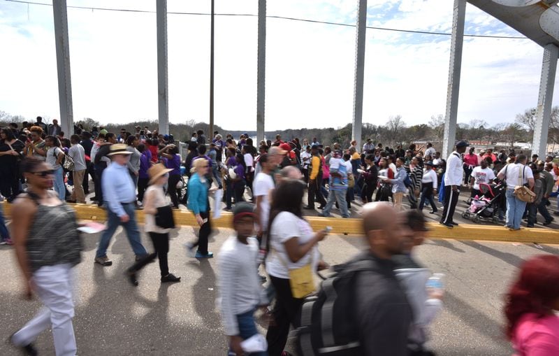 Crowds of people take a symbolic walk across the Edmund Pettus Bridge in Selma on Sunday, March 8, 2015. Thousands of people took part in a bridge crossing reenactment in Selma on Sunday to commemorate the 50th anniversary of Bloody Sunday. HYOSUB SHIN / HSHIN@AJC.COM