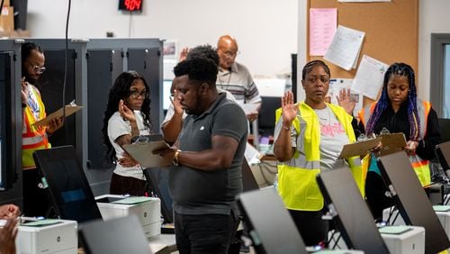 Elections employees get sworn in before beginning working. Dekalb County Elections officals conduct logic and accuracy testing of Dominion voting machines.  Monday, Sept. 16, 2024 (Ben Hendren for the Atlanta Journal-Constitution)