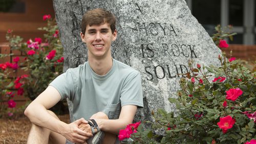 Jonathan Campbell, a senior at Harrison High School, poses for a portrait on Friday, May 12, 2023, at Harrison High School in Kennesaw, Georgia. Campbell overcame major health struggles to graduate, including a stroke and multiple surgeries. (CHRISTINA MATACOTTA FOR THE ATLANTA JOURNAL-CONSTITUTION)