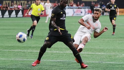 August 19, 2018 Atlanta: Atlanta United forward Josef Martinez makes the MLS season record tieing goal past Columbus Crew defender Jonathan Mensah for a 1-0 lead during the first half in a MLB soccer match on Sunday, August 19, 2018, in Atlanta.  Curtis Compton/ccompton@ajc.com