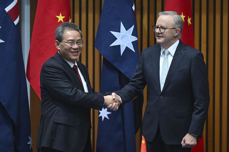 Chinese Premier Li Qiang, left, and Australia's Prime Minister Anthony Albanese shake hands during a signing ceremony at Parliament House in Canberra, Monday, June 17, 2024. Li and Albanese and senior ministers of both administrations met at Parliament House on Monday to discuss thorny issues, including lingering trade barriers, conflict between their militaries in international waters and China's desire to invest in critical minerals. (Lukas Coch/Pool Photo via AP)