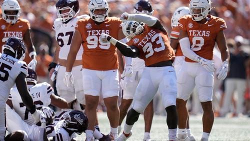 Texas linebacker David Gbenda (33) celebrates after a stop during the first half of an NCAA college football game against Mississippi State in Austin, Texas, Saturday, Sept. 28, 2024. (AP Photo/Eric Gay)