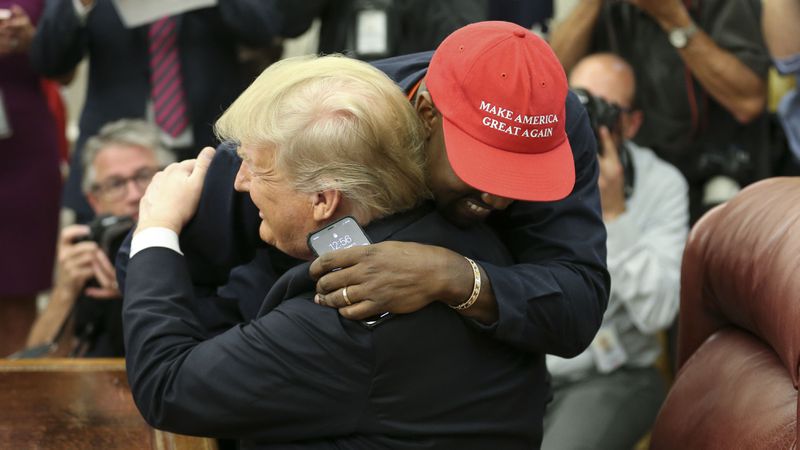 U.S. President Donald Trump hugs rapper Kanye West during a meeting in the Oval office of the White House on October 11, 2018 in Washington, DC.