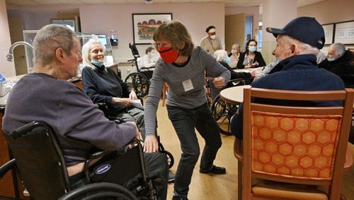 Karen Keeter, a volunteer, entertains senior residents during their morning gathering at the William Breman Jewish Home in Atlanta. The staff at Breman is now either fully vaccinated (97%) or have an exemption (3%). The community is able to resume more normalcy. (Hyosub Shin / Hyosub.Shin@ajc.com)