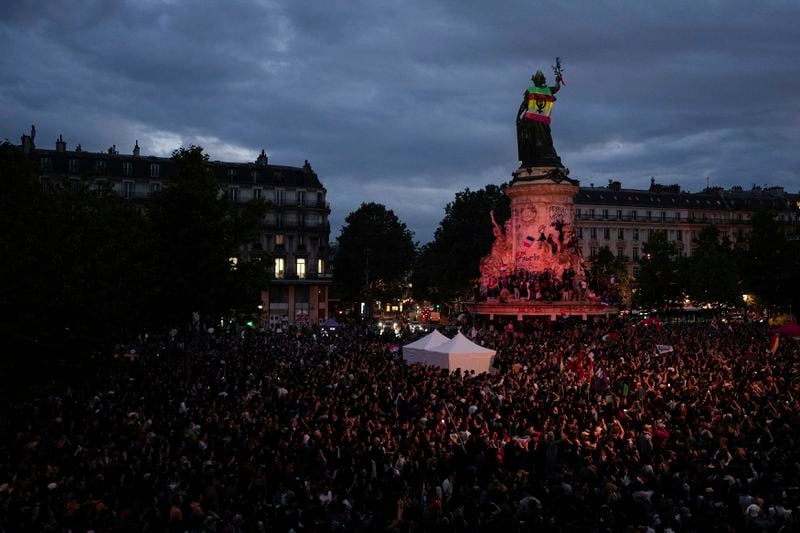 People gather at Republique plaza in a protest against the far-right, Wednesday, July 3, 2024 in Paris. French opposition parties and associations are trying to block a landslide victory for Marine Le Pen's far-right National Rally in next Sunday's second round of legislative elections. (AP Photo/Louise Delmotte)