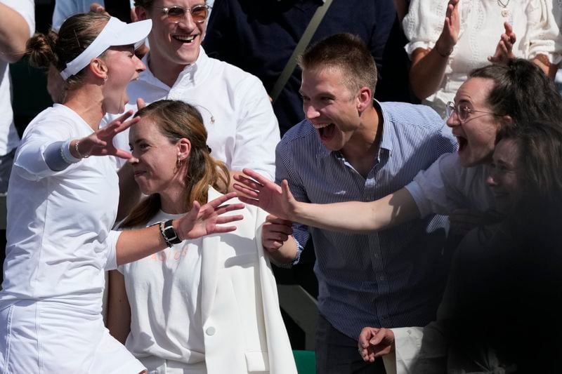 Barbora Krejcikova of the Czech Republic greets family and coaches in the players box as she celebrates after defeating Jasmine Paolini of Italy, to win the during the women's singles finalat the Wimbledon tennis championships in London, Saturday, July 13, 2024. (AP Photo/Mosa'ab Elshamy)