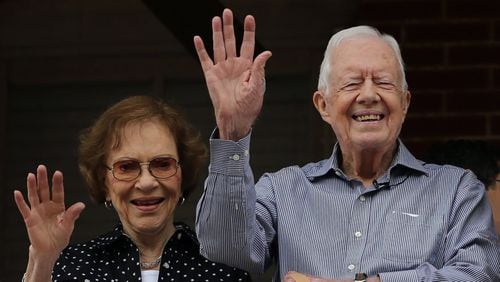 Former President Jimmy Carter and first lady Rosalynn Carter wave to a beauty queen during the Peanut Festival on Saturday Sept. 26, 2015, in Plains. The former president has been in hospice care since February 2023. Rosalynn Carter passed away in November. (Ben Gray/The Atlanta Journal-Constitution/TNS)