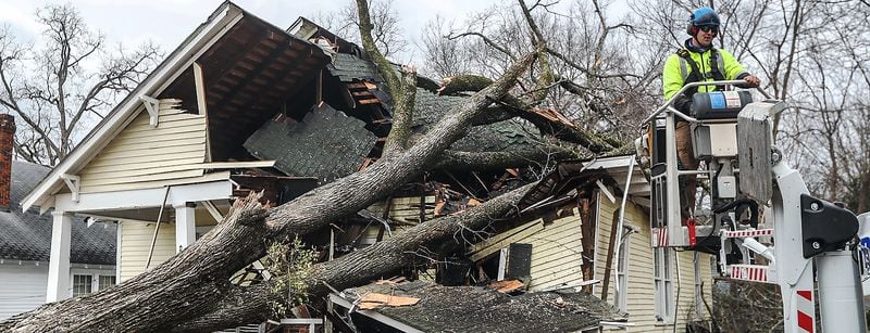 Adam Smith with Green Tree Service surveys the damage on West Chappell Street in Griffin.