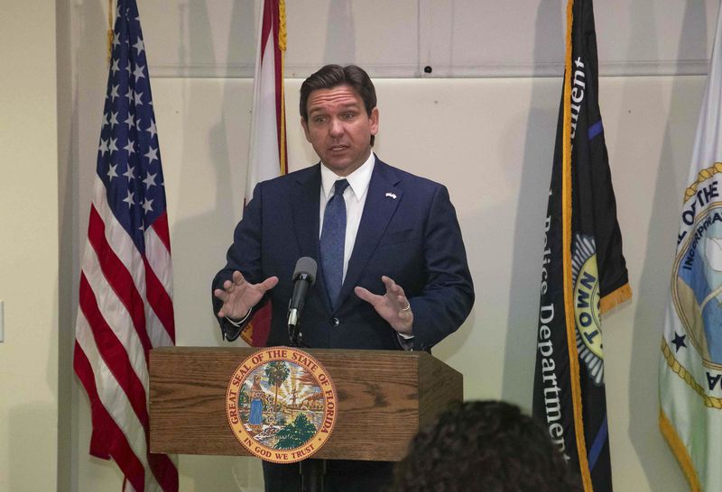 FILE - Florida Gov. Ron DeSantis speaks at the Palm Beach Police Department, Feb. 29, 2024, in Palm Beach, Fla., just before signing a bill to release the transcripts of a 2006 grand jury investigation that looked into sex trafficking and rape allegations made against Jeffrey Epstein. On Monday, July 1, 2024, Florida Circuit Judge Luis Delgado released the grand jury transcripts. (Damon Higgins/The Palm Beach Post via AP, File)
