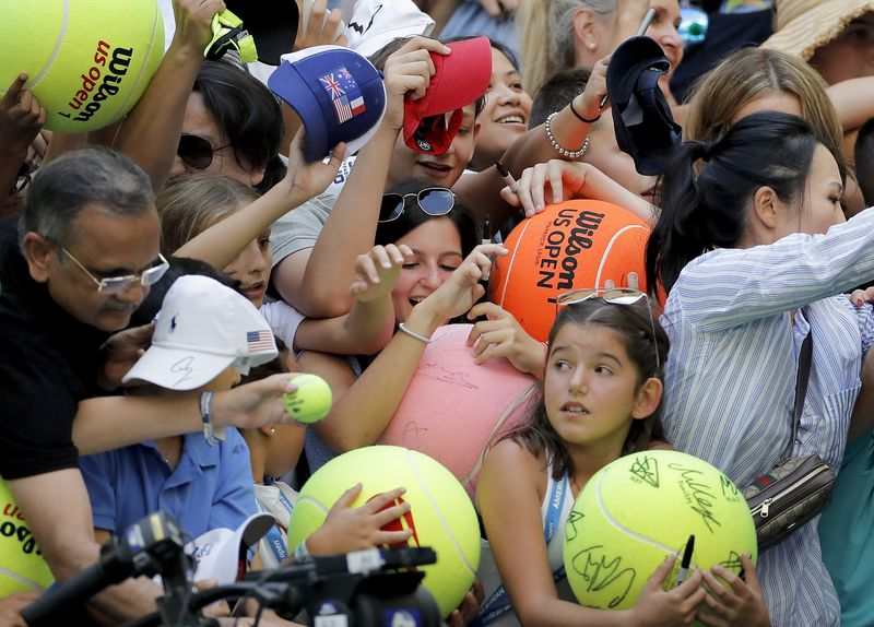 FILE - Tennis fans crowd the edge of the court hoping for an autograph from Rafael Nadal, of Spain, during round three of the U.S. Open tennis championships in New York, Aug. 31, 2019. This edition of the Grand Slam tournament at Roland Garros, which begins Sunday, is expected to be his last as the end of his career approaches after a series of injuries and limited play the past two seasons.(AP Photo/Eduardo Munoz Alvarez, File)