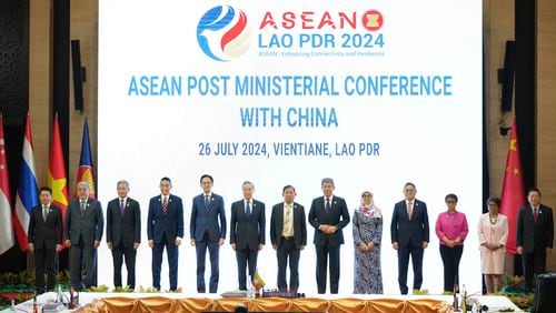 Chinese Foreign Minister Wang Yi, 6th from left, poses for group photos with ASEAN ministers and delegates during the ASEAN Post Ministerial Conference with China at the Association of Southeast Asian Nations (ASEAN) Foreign Ministers' Meeting in Vientiane, Laos, Friday, July, 26, 2024. (AP Photo/Achmad Ibrahim)