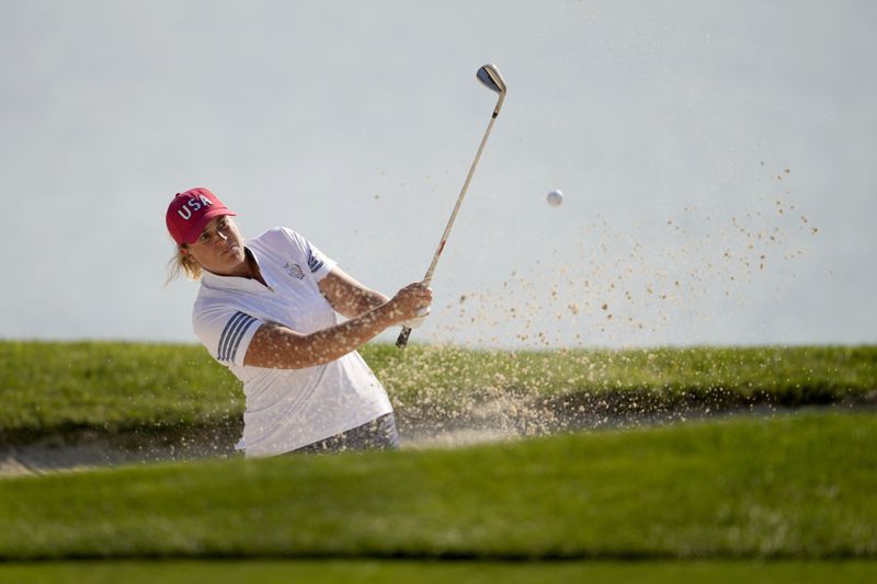 United States' Lauren Coughlin hits from a bunker on the 10th hole during a Solheim Cup golf tournament foursome match at Robert Trent Jones Golf Club, Saturday, Sept. 14, 2024, in Gainesville, Va. (AP Photo/Matt York)