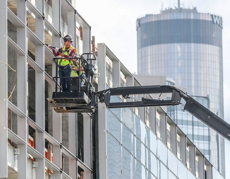 September 12, 2022 Atlanta: Workers continued building at the Georgia World Congress Center Authority's new headquarter hotel Signia by Hilton as the The Westin Peachtree Plaza, Atlanta hotel looms in the background on Monday, Sept. 12 2022. (John Spink / John.Spink@ajc.com)