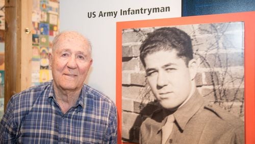 Hilbert Margol, 94, stands beside the display featuring his story in the new “American Witnesses” exhibition at the U.S. Holocaust Memorial Museum in Washington, D.C.