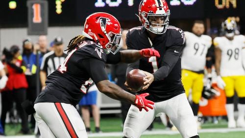 Falcons quarterback Marcus Mariota hands the ball to running back Cordarrelle Patterson during the third quarter against the Steelers on Sunday in Atlanta. (Miguel Martinez / miguel.martinezjimenez@ajc.com)