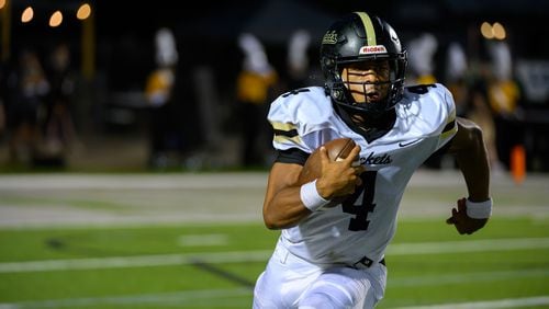 Jaden Duckett, quarterback for Sprayberry High School, runs the ball during the Sprayberry at Kennesaw Mountain high school football game in Kennesaw, GA on August 30, 2024. (Jamie Spaar for the Atlanta Journal Constitution)