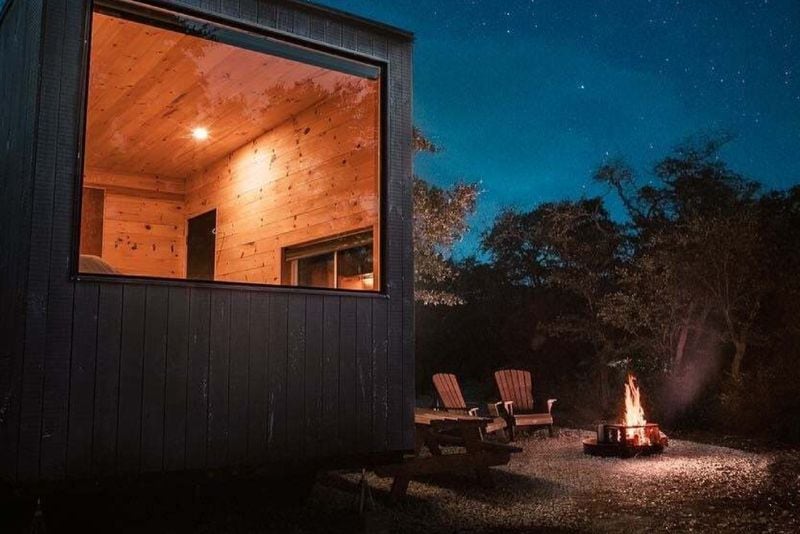 All tiny cabins at Getaway Outposts have large picture-frame windows next to queen beds and firepit patio areas for taking in the natural scenery.
(Courtesy of Getaway House)