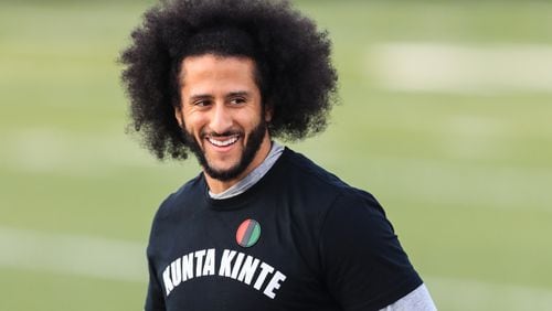 Colin Kaepernick looks on during a private NFL workout Saturday at Charles Drew High School in Riverdale.