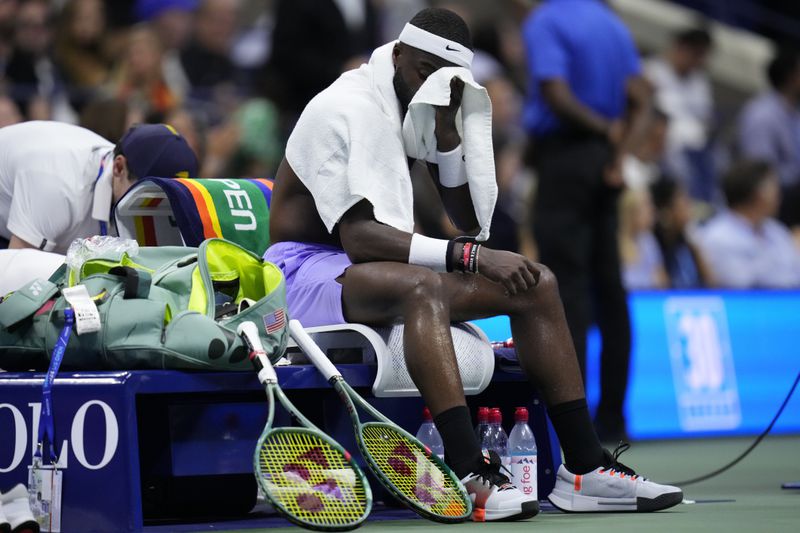 Frances Tiafoe, of the United States, wipes his face between games against Taylor Fritz, of the United States, during the men's singles semifinals of the U.S. Open tennis championships, Friday, Sept. 6, 2024, in New York. (AP Photo/Kirsty Wigglesworth)