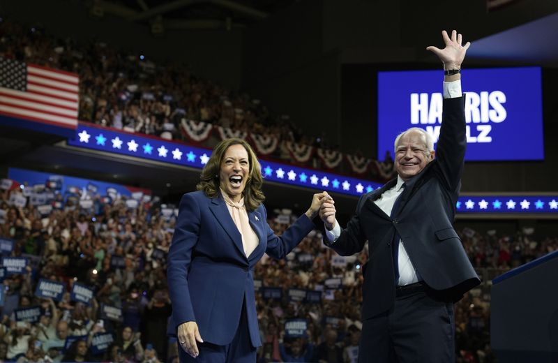 FILE - Democratic presidential nominee Vice President Kamala Harris accompanied, left, by her running mate Minnesota Gov. Tim Walz, appear at a campaign event in Philadelphia, Aug. 6, 2024. (AP Photo/Matt Rourke, File)