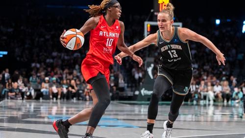 Atlanta Dream guard Rhyne Howard (10) is defended by New York Liberty forward Leonie Fiebich (13) during the second half of a WNBA basketball first-round playoff game Sunday, Sept. 22, 2024, in New York. (AP Photo/Corey Sipkin)