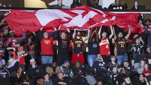 Atlanta Hawks fans cheer with an Atlanta Hawks flag guard during the second half of the Hawks’ game against the Orlando Magic at State Farm Arena, Wednesday, January 17, 2024, in Atlanta. The Hawks won 106-104. (Jason Getz / Jason.Getz@ajc.com)