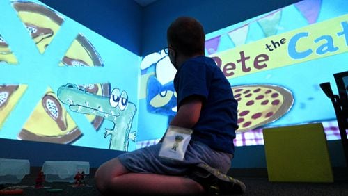 July 12 , 2022 Tucker - A summer camp participant plays and learns using technology in sensory room during a summer camp for children with special needs at Lekotek of Georgia in Tucker on Tuesday, July 12, 2022. Children with and without disabilities play and learn together in an environment that facilitates success. (Hyosub Shin / Hyosub.Shin@ajc.com)