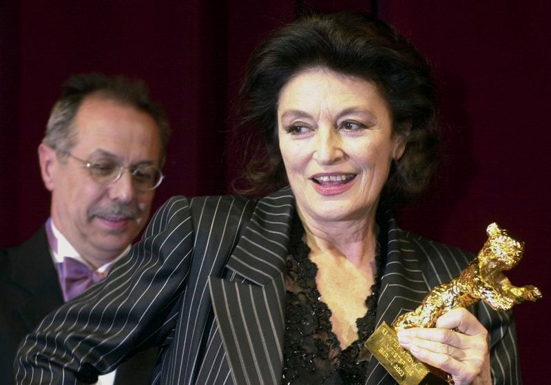 FILE - French actress Anouk Aimee holds a Golden Bear award which she was given for lifetime achivement at the 53rd Berlinale Film Festival in Berlin Thursday, Feb. 13, 2003. French actress Anouk Aimée, winner of a Golden Globe for her starring role in "A Man and a Woman" by legendary French director Claude Lelouch, has died, her agent said Tuesday. She was 92. (AP Photo/Sven Kaestner, File)