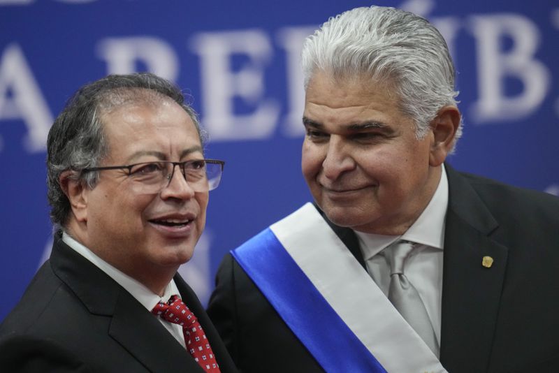 New Panamanian President Jose Raul Mulino smiles as Colombian President Gustavo Petro looks on as they leave Mulino's swearing-in ceremony at the Atlapa Convention Centre in Panama City, Monday, July 1, 2024. (AP Photo/Matias Delacroix)
