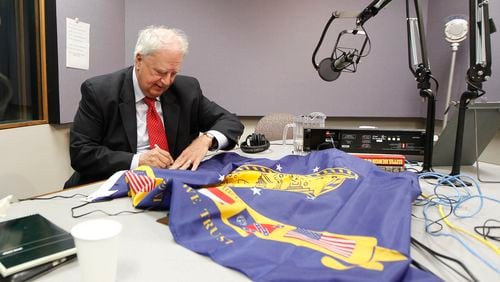 Prior to a GPB radio show, former Gov. Roy Barnes signs the state flag that replaced the 1956 version with its Confederate battle emblem. It flew from 2001 to 2003, when it replaced by the current one. Tami Chappell / Special to the AJC