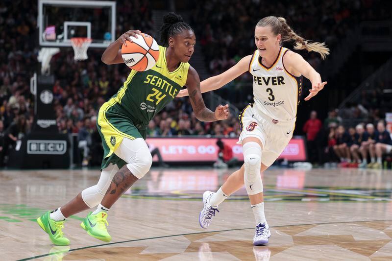 Seattle Storm guard Jewell Loyd (24) drives against Indiana Fever guard Kristy Wallace (3) during the first half of a WNBA basketball game Wednesday, May 22, 2024, in Seattle. (AP Photo/Jason Redmond)