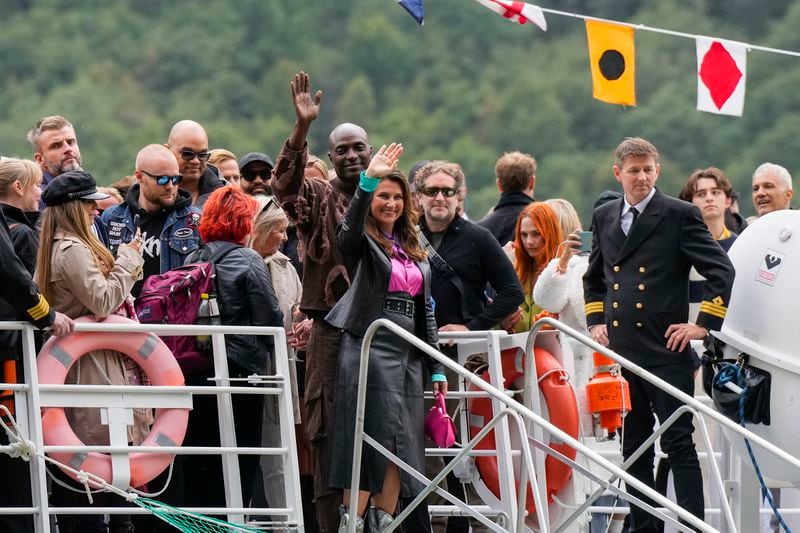 Norway's Princess Martha Louise, center, and Durek Verret, rear center, and guests arrive from Alesund to Geiranger, Norway, Friday Aug. 30, 2024, ahead of their wedding celebration on Saturday. (Cornelius Poppe/NTB via AP)