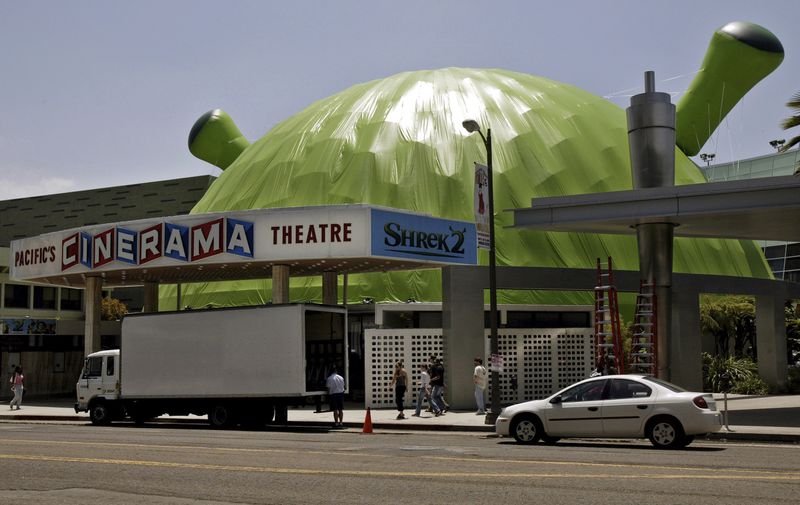 FILE - The dome of the Cinerama theatre is covered by green plastic in the form of animated character Shrek to promote the film "Shrek 2" in Los Angeles on May 19, 2004. (AP Photo/Kevork Djansezian, File)