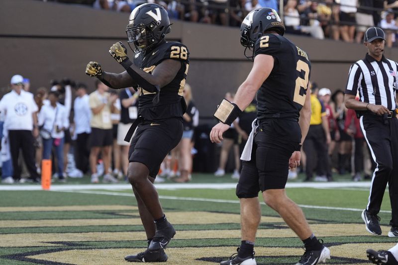 Vanderbilt running back Sedrick Alexander (28) celebrates a touchdown with quarterback Diego Pavia (2) during the first half of an NCAA college football game against Alabama, Saturday, Oct. 5, 2024, in Nashville, Tenn. (AP Photo/George Walker IV)