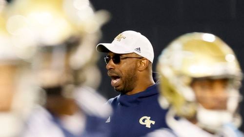 Georgia Tech defensive line coach Marco Coleman yells instructions during a practice.